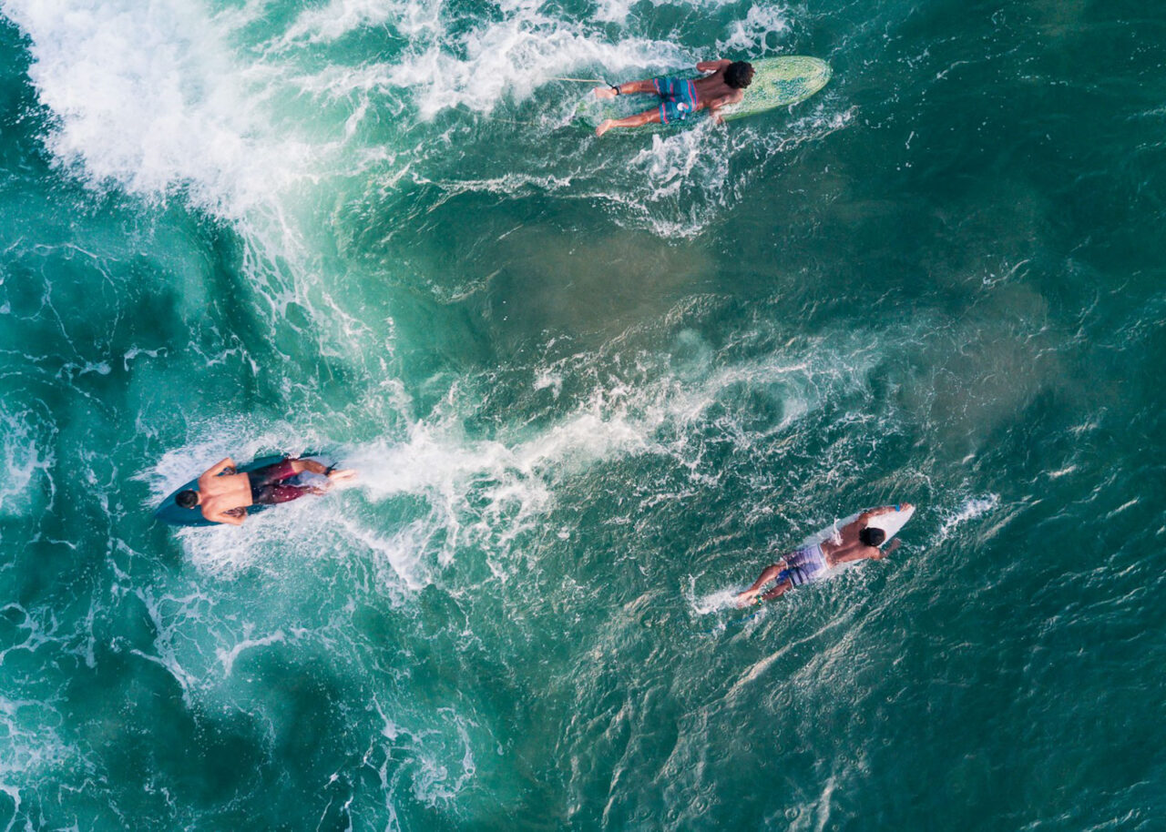 Drone shot of surfers on the water in Bali